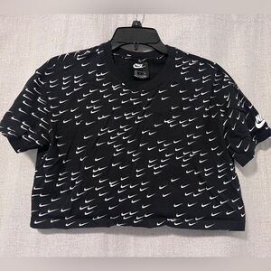 Nike Women's Black Crop Top with White Swoosh Pattern. Size: Small